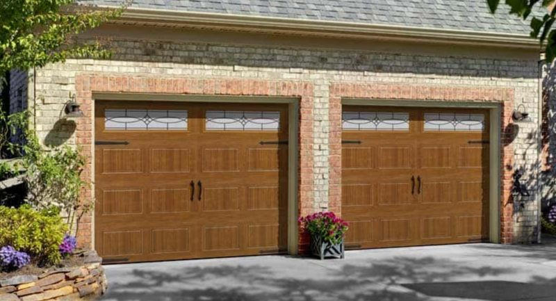 Garage doors with decorative hardware and window inserts