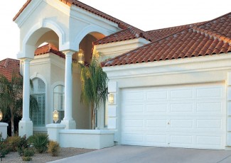 Large White House with an aluminum garage door